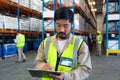 Male worker writing on clipboard in warehouse Royalty Free Stock Photo