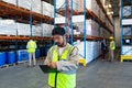 Male worker writing on clipboard in warehouse Royalty Free Stock Photo