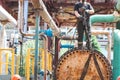 Male workers assemblers mount a shell-and-tube heat exchanger, repair equipment at an oil refining petrochemical chemical