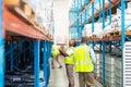 Male workers checking stocks in warehouse