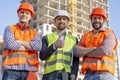 Group of construction engineers on a building plot. High-rise building skyscraper background Royalty Free Stock Photo