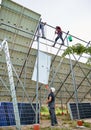 Male workers installing photovoltaic solar panels outdoors. Royalty Free Stock Photo