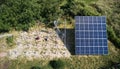 Male workers installing solar panel system outdoors.