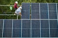 Male workers installing solar panel system outdoors. Royalty Free Stock Photo