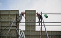 Male workers installing solar panels on metal construction. Royalty Free Stock Photo