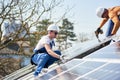 Installing solar photovoltaic panel system on roof of house Royalty Free Stock Photo
