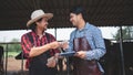 Male workers pay money and shake hands with farmers on the dairy farm.Agriculture industry, farming and animal husbandry concept , Royalty Free Stock Photo