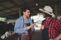 Male workers pay money and shake hands with farmers on the dairy farm.Agriculture industry, farming and animal husbandry concept , Royalty Free Stock Photo