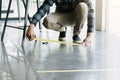 Male workers preparing masking tape to symbolize social distances