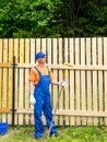 Male workman resting near the wooden fence