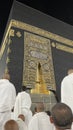 Male worshipers pray at the door of the Kaaba