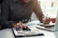 Male writes information businessman working on smartphone writing business plan while sitting in office.