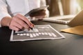 Male writes information businessman working on laptop computer and tablet.