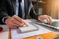 Male writes information businessman working on laptop computer.