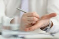 Male writing note with silver pen on his hand to keep in mind some information Royalty Free Stock Photo