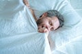 Male yawning on pillow. Gray hair man yawn in white bed. Senior man yawning in bed at bedroom. Man morning yawning at Royalty Free Stock Photo