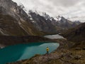 Male yellow jacket hiker Cordillera Huayhuash Circuit andes mountain Mirador Tres Lagunas three lakes view Huanuco Peru Royalty Free Stock Photo