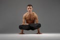 Male yoga keeps balanc on hands in classical pose Royalty Free Stock Photo