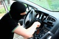 The malefactor in the mask stealing car Royalty Free Stock Photo
