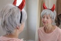 Malevolent senior woman with demon horns