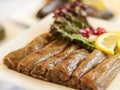 MALFOOF or Stuffed Cabbage leaves rolls with lime and salad served in dish isolated on wooden table top view of cold mazza arabic