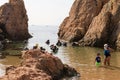 Malgrat de Mar, Catalonia, Spain, August 2018. A group of divers preparing to dive, a little boy imitating adults. Royalty Free Stock Photo