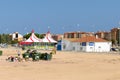 Malgrat de Mar, Catalonia, Spain, August 2018. Garbage cans and scavengers on the background of a circus tent and the police stati