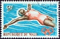 MALI - CIRCA 1965: A stamp printed in Mali from the `1st African Games, Brazzaville` issue shows backstroke swimmer, circa 1965.