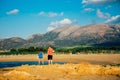 Pair of young people, a woman and a man, admire the view of the mountains during the