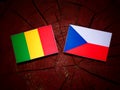 Malian flag with Czech flag on a tree stump