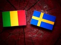 Malian flag with Swedish flag on a tree stump