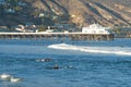 Malibu, California, USA - September 2016: Surfing people ride on the waves