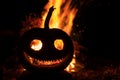 Malicious grin pumpkin head with a fire in the background