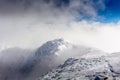 Maliovica peak in the mists of the clouds at the Rila mountain in Bulgaria