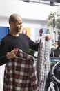 Mall customer browsing plaid shirts Royalty Free Stock Photo