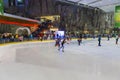 People skating in a mall with an indoor ice skating park