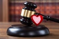 Mallet And Heart On Table In Courtroom Royalty Free Stock Photo