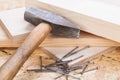 Mallet with nails and planks of new wood