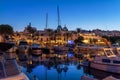 Puerto Del Sol in Cala d\'Or, with illuminated sailboats reflected on the water