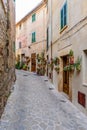 Beautiful street with stone buildings decorated with flowers in Valldemossa old town Royalty Free Stock Photo