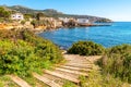 Mallorca island, beach in Sant Elm. Seashore, azure sea and buildings