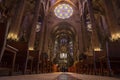 Low angle view of stained glass ceiling and pews at gothic La Seu Cathedral Royalty Free Stock Photo