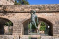 Male statue on promenade against surrounding wall at La Seu Cathedral Royalty Free Stock Photo