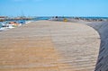 Curved wood jetty and moored boats in Can Pastilla