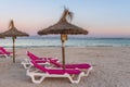 Sunbeds with umbrellas at the Playa de Alcudia beach in Mallorca, Spain