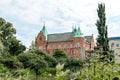 MalmÃÂ¶, Sweden - July 19, 2019: The old castle like building is housing the city library. It stands in the middle of a green park