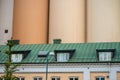 Tall grain silo behind roof apartments in an old building..