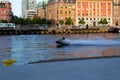 MalmÃÂ¶, Sweden - June 17, 2019: Young men riding water jetski scooter in the canal even if it is forbidden
