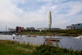 MalmÃÂ¶, Sweden - September 1, 2019: A person is practicing wake boarding in the canal close to the skyscraper Turning Torso, seen