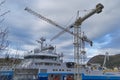 Maloy, Norway - 30th March 2011: A pair of Shipyard Cranes working over a Seismic Vessel in a Drydock.